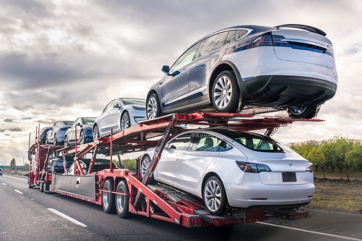 Car being loaded onto a transport truck for interstate delivery