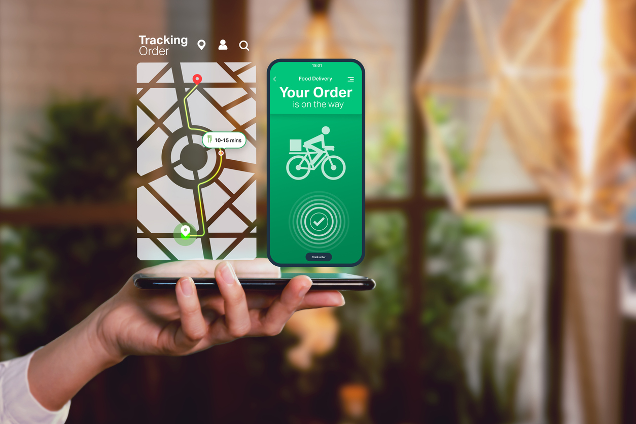 Person booking a delivery on a logistics app on a smartphone