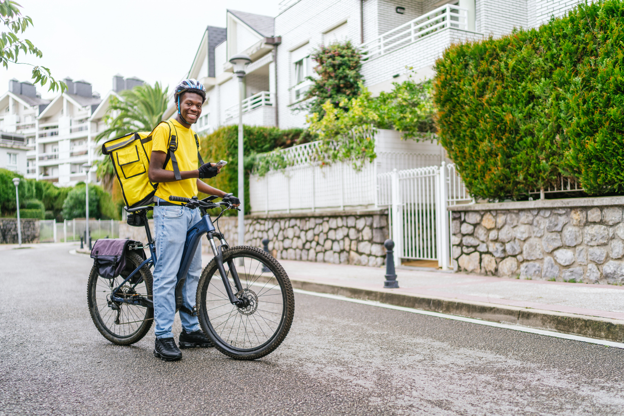 Dispatch rider on a delivery motorcycle in Lagos traffic
