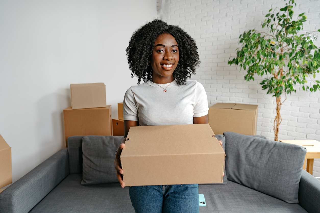 Shopping online on a laptop with parcels ready for delivery to Nigeria