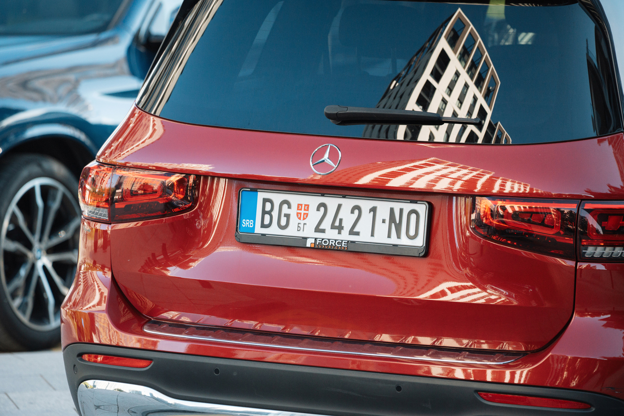 Car owner fitting a personalised number plate