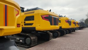 Yellow excavators parked in a row